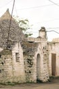 Ancient Trullo roof in the countryside, traditional old house and old stone wall in Puglia, Italy Royalty Free Stock Photo