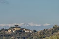 The ancient Tuscan village of Legoli, Pisa, Italy, with the snow capped Apennine mountains in the background Royalty Free Stock Photo