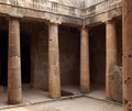 The ancient burial chamber with columns and doorway of tomb number 3 at the tomb of the Kings` necropolis in Paphos, Cyprus. Royalty Free Stock Photo