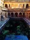 Ancient underground well with a water pool in Delhi