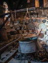 Ancient utensils and hearth with a boiler in the ancient kitchen in the Megala Meteora monastery in Meteora region, Greece