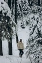 Ancient viking hunter walking in snow winter forest with steel a