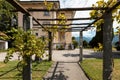 Ancient villa entrance with stone porch and wooden logs Royalty Free Stock Photo