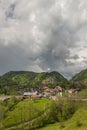 Ancient village among the Romanian Carpathian mountains with a storm about Royalty Free Stock Photo