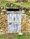 Ancient and vintage blue door, stones and nature