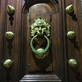 Ancient vintage door, golden details, lion face, history and time Royalty Free Stock Photo