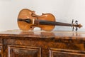 Ancient Violin Resting on an Antique Wooden Furniture