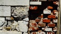 Ancient wall of bricks and scraps of stone with a weathered geometric pattern