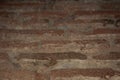 Ancient wall of broken obsolete bricks, soft focus