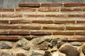 Ancient wall reddish bricks and concrete.