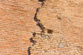 Ancient wall several layers of red brick, the crack collapses