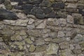 Ancient walls built of gray and black stone base natural background Royalty Free Stock Photo