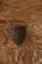 Ancient warrior shield with little shadow on the old wall in a Castle Bobolice Royalty Free Stock Photo