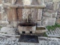 Ancient water column with modern pipe and tap outdoors in Ankara Castle Turkey. Drinking fountain against the background of old Royalty Free Stock Photo