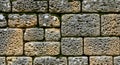 Ancient weathered porous stone wall texture with moss Royalty Free Stock Photo