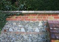Ancient weathered wall showing a combination of bricks, files and flint