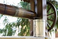 Ancient well with drinking water and a metal bucket with cross sign Royalty Free Stock Photo