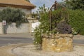 Ancient well in the middle of a roundabout in a french village Royalty Free Stock Photo