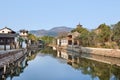 Ancient white Chinese houses reflected in a canal, Hengdian, China