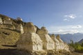 A ancient white holy Tibetan Buddhist temples on a desert mountain in the daytime against the backdrop of a mountain valley Royalty Free Stock Photo