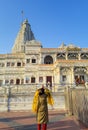 ancient white marble architecture with devotee offering salutation at dusk from flat angle Royalty Free Stock Photo
