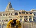ancient white marble architecture with devotee offering salutation at dusk from flat angle Royalty Free Stock Photo