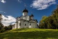 Ancient white orthodox christian stone temple. Pskov region, Russia. Church of St. Basil the Great on a hill against a background Royalty Free Stock Photo