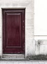 Ancient White Wall With a Purple Door on a Street in Oxford UK