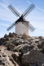 Ancient wind mill in rocky landscape in of Region of Castilla la Mancha, Spain in a sunny day Royalty Free Stock Photo