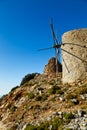Ancient windmill against bright blue sky of Lasithi Plateau on Crete, Greece Royalty Free Stock Photo