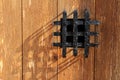 Ancient window black metal jail grid wooden door