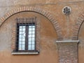 Ancient window with iron bars in di Querceti street to Rome in Italy.