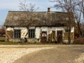 An ancient, wooden and abandoned dilapidated house in a village where no one lives anymore, a retro legacy of the last century.