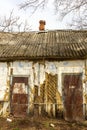 An ancient, wooden and abandoned dilapidated house in a village where no one lives anymore, a retro legacy of the last century.