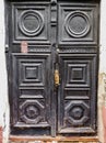 ancient wooden black doors with infill and door handle Royalty Free Stock Photo