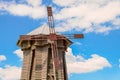 Ancient wooden blockhouse wind mill under blue sky