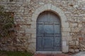 Ancient wooden blue arcade door at a wall of old building Royalty Free Stock Photo