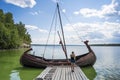 An ancient wooden boat on the pier in the Bogatyrskaya Sloboda in the Samara region in Russia. A clear sunny day on July