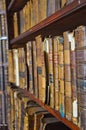 Ancient wooden book shelves with old library books Dusty bookshelf with rare books collection in bookcase Retro library