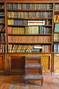 Ancient wooden book shelves with old library books Dusty bookshelf with rare books collection in bookcase Retro library Royalty Free Stock Photo