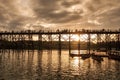 Ancient wooden bridge with tourists travel at sunset