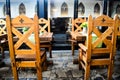Ancient wooden chairs with medieval decorations in vintage restaurant with many feudal ages decor elements Royalty Free Stock Photo