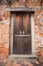 Ancient wooden door on brick wall Royalty Free Stock Photo