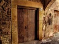 Ancient wooden door of a former brothel with the sign `Magic` on the medieval street of Cervera town Spain, close-up. Vintage