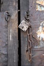 Ancient wooden door with iron lock and chain