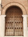 Ancient wooden door from Italy. Medieval stone wall Royalty Free Stock Photo