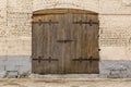 Ancient wooden door in old stone castle wall Royalty Free Stock Photo