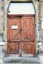 Ancient wooden door in old stone castle wall. Royalty Free Stock Photo