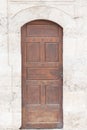 Ancient wooden door in old stone castle wall Royalty Free Stock Photo