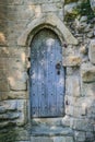 Ancient wooden door in old stone castle wall, Knaresborogh Royalty Free Stock Photo